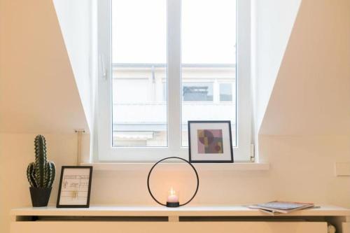 a table with a mirror and a window at Studio Fischer à la Pétrusse 302 in Luxembourg