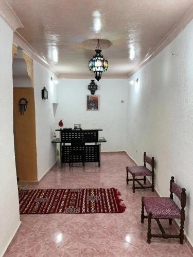 a living room with a piano and two chairs at House andalous in Fez