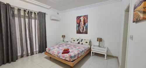 a bedroom with a bed and two night stands and a window at Sea View apartment on Promenade S1 in Sliema