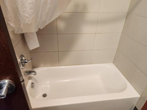 a bathroom with a white tub and a sink at Sleep Inn & Suites Blackwell I-35 in Blackwell