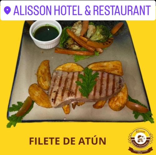a plate of food with meat and vegetables and sauce at Alisson Hotel y Restaurant in Monteverde Costa Rica