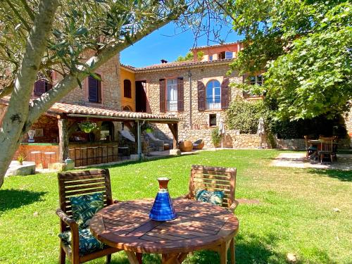 a table with a blue vase sitting on top at Domaine De Sainte Annette in Callian