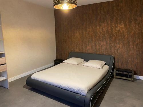 a bedroom with a bed with two pillows on it at Les Croisés&Spa in Azannes-et-Soumazannes