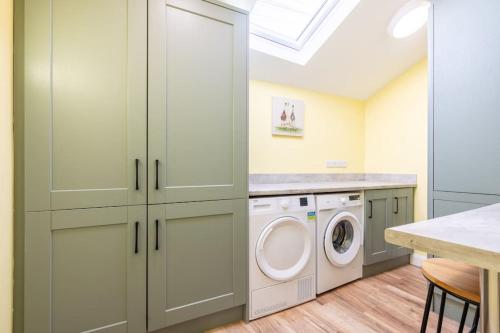 a laundry room with a washer and dryer at Boutique Homes At 4 in Bangor