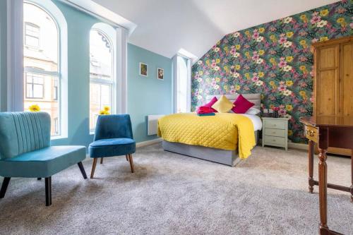 a bedroom with a bed with a floral wall at Boutique Homes At 4 in Bangor