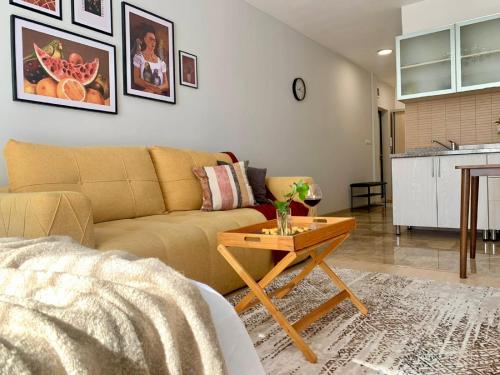 a living room with a couch and a table at Apart Complex Молодежный из 20 отдельных апартаментов в центре города in Almaty
