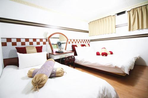 Una cama o camas en una habitación de Sheng-Kuo Hotel