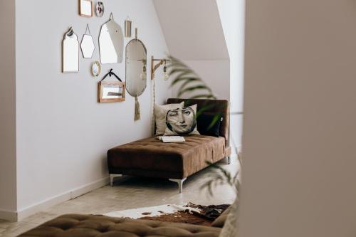 a living room with a couch and a chair at Dandy's Blue Apartments in Setúbal