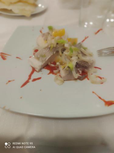 a plate of food on a white plate at ITALIA GUESTHOUSe in Milis
