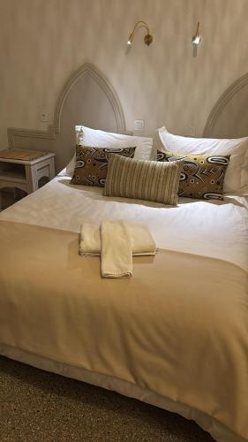 a large white bed with two towels on it at Résidence Mer et soleil in Agadir