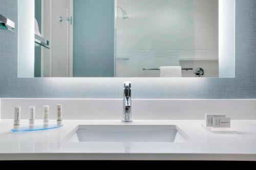 a bathroom with a sink and a mirror at Residence Inn by Marriott Kingston in Kingston
