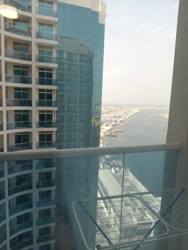 a view of a building from a glass balcony at 2BHK apt Creek view Ajman UAE in Ajman 