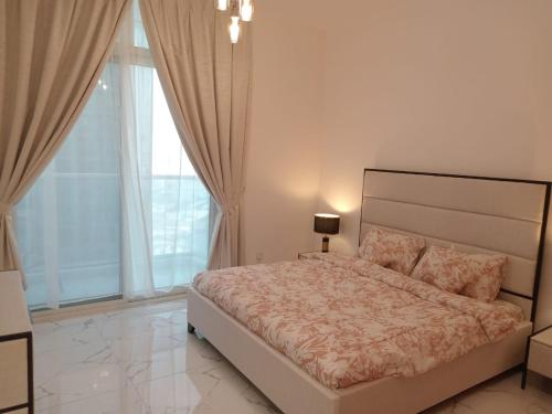 a bedroom with a large bed and a large window at 2BHK apt Creek view Ajman UAE in Ajman 