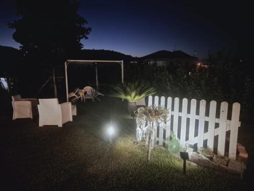 a white fence in a yard at night at CASE DI BACCO in Agropoli