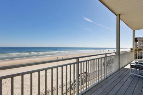 a balcony with a view of the beach at Coastal Waters in New Smyrna Beach