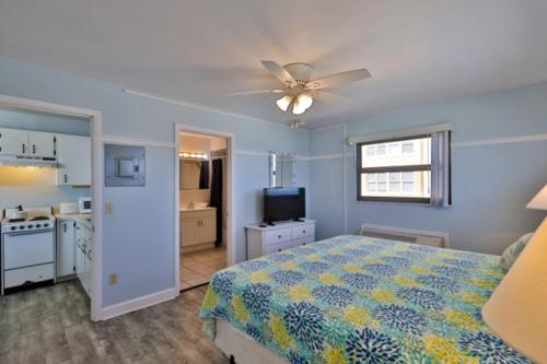 a bedroom with a bed and a ceiling fan at Coastal Waters in New Smyrna Beach