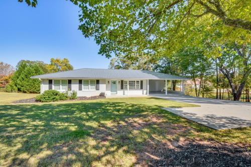 a white house with a large yard at Lake Keowee Home with Boat Dock in Seneca in Seneca