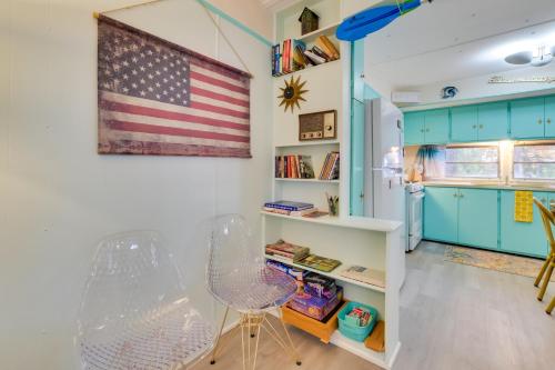a room with an american flag on the wall at Walk to Manistee Lake Retro Cottage with Fire Pit! in Kalkaska