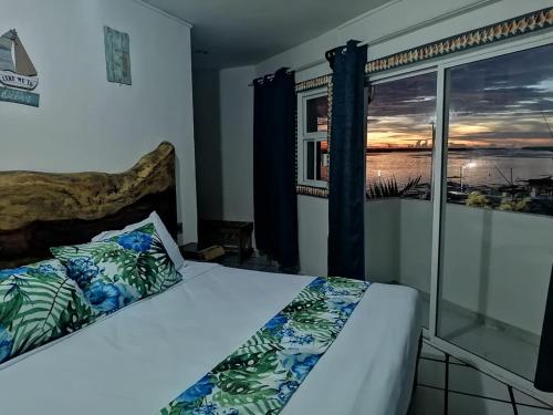 a bedroom with a bed with a view of the ocean at Hotel y Restaurante Macumba in Río Lagartos