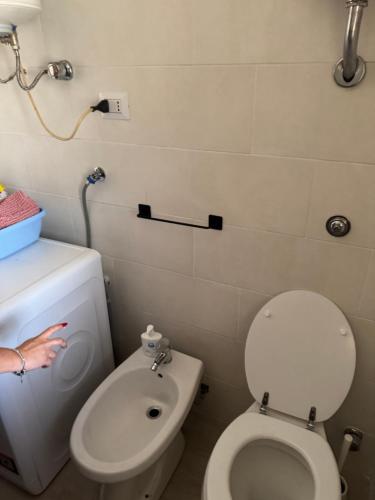 a bathroom with a white toilet and a sink at Aba Gianola in Formia