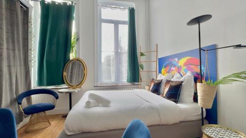 a bedroom with a bed and a chair and a window at 05 -BALI Style Room - Tourcoing in Tourcoing