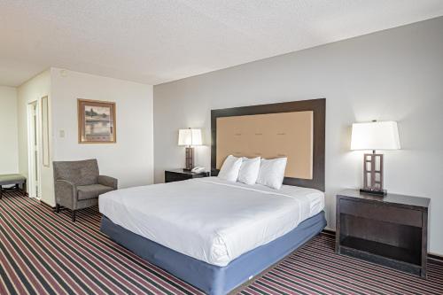 a hotel room with a bed and a chair at Motel 6 Pocatello ID in Pocatello