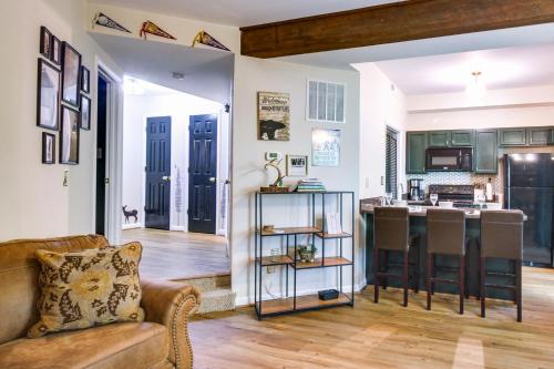 a living room with a couch and a kitchen at Wintergreen Resort Condo with Deck, 0 3 Mi to Slopes in Lyndhurst