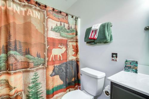a bathroom with a toilet and a shower curtain with a deer at Wintergreen Resort Condo with Deck, 0 3 Mi to Slopes in Lyndhurst