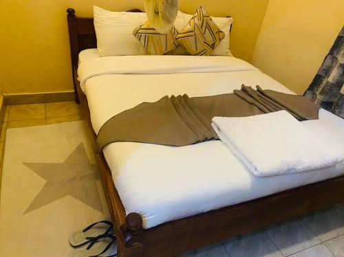 two twin beds in a room with at Villa Serene Hotel in Kitale