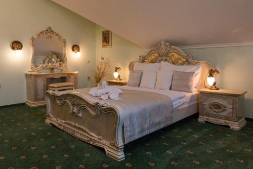 a bedroom with a large bed and a mirror at Hotel Viliam Frano in Nitra