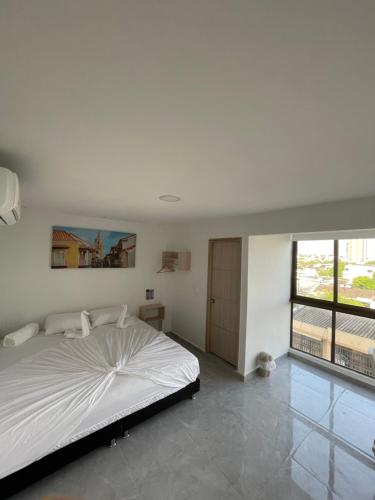Postel nebo postele na pokoji v ubytování Hotel La Estrella de David Cartagena