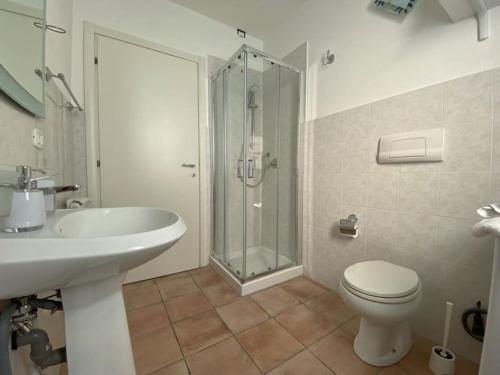 a bathroom with a toilet and a sink and a shower at Appartamento Bellavista in Terricciola