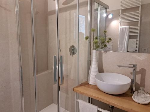 a bathroom with a glass shower with a sink and a toilet at Residenza Sant'Angelo in Spello
