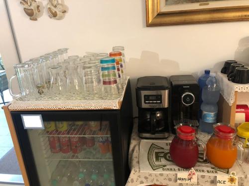 a refrigerator filled with glasses and a coffee maker at I Broletti del Garda in Pacengo di Lazise
