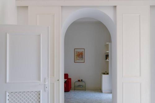 a hallway with an archway in a white room at Dolce Vita Beach House stunning views by the sea in Capri