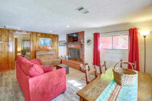 a living room with a pink couch and a table at 10 Mi to National Park Patio at Hot Springs Home in Hot Springs
