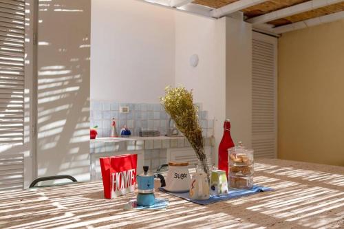a table with a vase of flowers in a kitchen at Dolce Vita Beach House stunning views by the sea in Capri