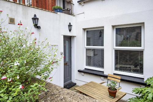 a house with a wooden table and a window at 1 Bed flat in East Dulwich in London