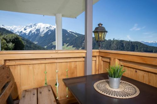 a balcony with a table and a view of mountains at Alpenrelax Krepperhütte in Volders