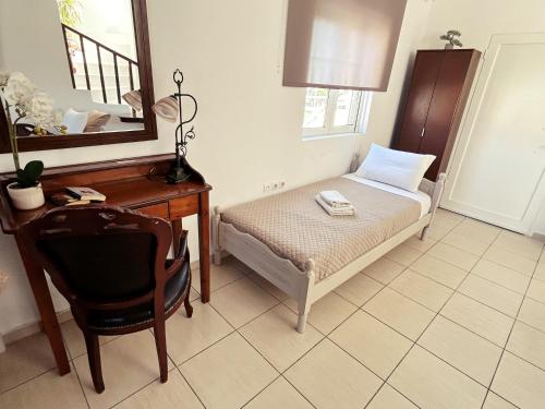 a bedroom with a bed and a desk and a mirror at PEDRO NAVARINO ΙΙΙ Laganas in Laganas