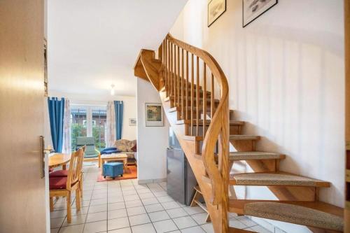 a staircase in a house with a dining room at Haus Clara in Neßmersiel