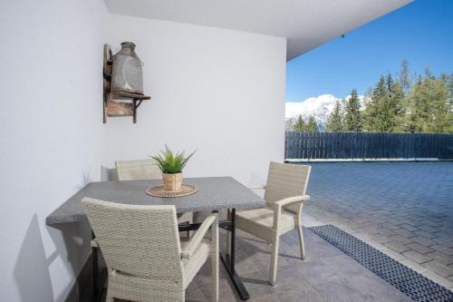 a dining room with a table and chairs on a patio at Alpenrelax Krepperhütte in Volders