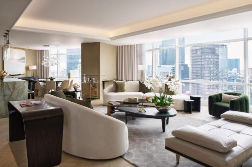 a living room with furniture and a large window at The St. Regis Mexico City in Mexico City