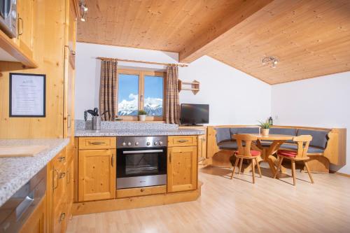 a kitchen and dining room with a table and a dining room at Alpenrelax Krepperhütte in Volders