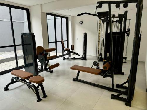 a gym with several exercise equipment in a room at Stúdio 81 Tatuapé Aconchegante in Sao Paulo