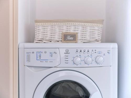 a white washing machine with a basket on top of it at Two Bedroom Cycladic House With Sea View in Kampos Paros