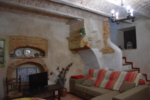 a living room with a couch and a fireplace at Santa Ana in Alburquerque
