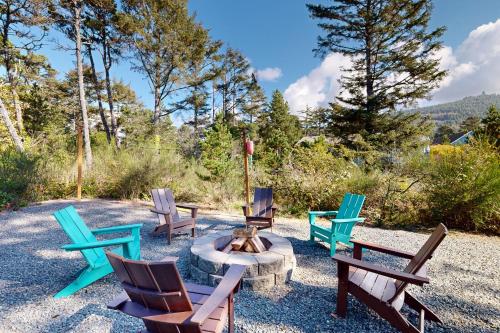 a group of chairs sitting around a fire pit at The Ocean Dream in Rockaway Beach