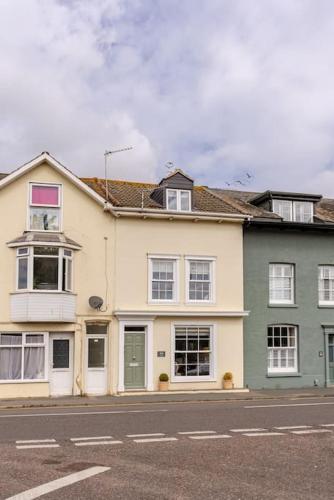 a large house on the side of a street at Stunning new Duplex apartment - Christchurch in Christchurch