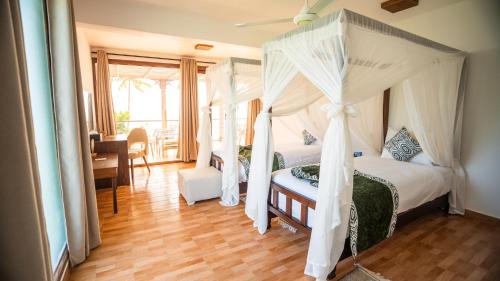 Ένα ή περισσότερα κρεβάτια σε δωμάτιο στο Dream of Zanzibar Resort & Spa - Premium All Inclusive